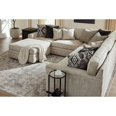 a living room filled with furniture and a large rug on top of a hard wood floor