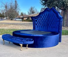 a large blue bed sitting on top of a sidewalk