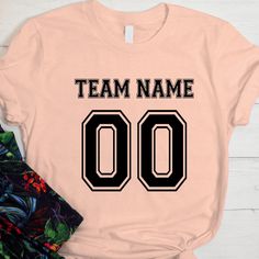 Personalized Football Jersey, Customized Football Jersey, Team Fan Tshirt, Team Adult Women Jersey, Make Your Own Team Name Shirt  🌟 How to Order:  1️⃣ Check all photos carefully. 2️⃣ Select your t-shirt size and color. Note: Slight color variations may occur due to different brands. For exact color matching, choose the same style (e.g., Unisex, V-necks, Toddler). 3️⃣ Add to cart, and feel free to add more items. 4️⃣ Proceed to checkout. 5️⃣ Add any special requests in the "Note to Seller" sect Cheap Letter Print Jersey For Fan Gear, Pink Team Name Tops For Team Events, Pink Tops With Team Name For Team Events, Pink Team Spirit T-shirt With Team Name, Team Spirit Pink T-shirt With Team Name, Pink Crew Neck T-shirt With Team Name, Pink Crew Neck Top For Team Spirit, Cotton Tops With Sublimation Print For Team Events, Graphic Tee With Letter Print For Team Events