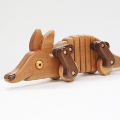 a wooden toy animal that looks like a mouse