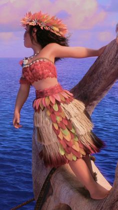 a woman in a costume standing on top of a tree next to the ocean,