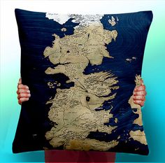 a person holding up a pillow with the map of europe on it in front of a blue background