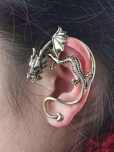 an ear piercing with a dragon design on the front and back of it's ear