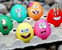 an egg carton filled with different colored eggs and cartoon characters painted on the eggs