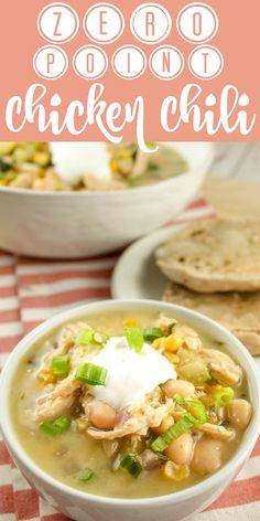 a bowl of chicken chili with sour cream on top and pita bread in the background