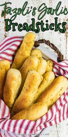 a basket filled with breadsticks sitting on top of a red and white towel