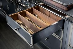 an open drawer with utensils in it