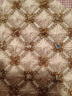 a close up view of the fabric with beads and sequins on it's edges