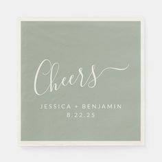 a mint green and white wedding napkin with the word cheers printed in cursive font