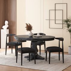 a dining room table with four chairs around it