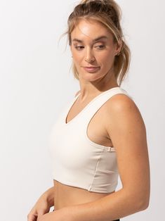 The cutest crop around! The Maliha Twist-Back Crop Top sports a fashionable twist-back detail, while working as a sports bra & active top all in one. This Bra does not have built in pads. Versatile Activewear Crop Top With Built-in Bra, Casual Crop Top With Built-in Bra For Pilates, Light Exercise Crop Top With Medium Bust Support, Medium Bust Support Crop Top For Pilates, White Crop Top Sports Bra With Built-in Bra, White Crop Top Sports Bra With Built-in Support, White Bra-friendly Athleisure Crop Top, White Athleisure Crop Top Bra-friendly, White Seamless Cropped Activewear