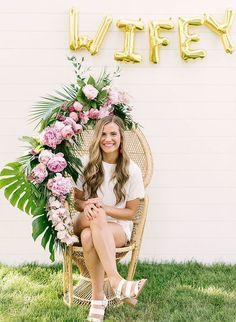 a woman sitting in a chair with flowers on her head and the words happy written above her