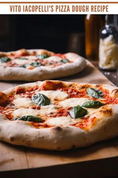 two pizzas sitting on top of a wooden cutting board