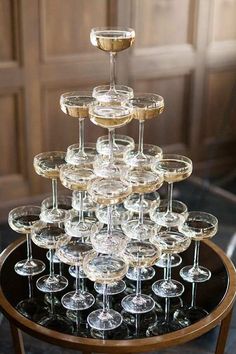 there are many wine glasses stacked on top of each other