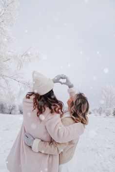 two people in the snow hugging each other