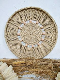 a wicker basket with eggs in it on the floor next to some dried grass