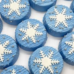 snowflake cookies sitting on top of a white table