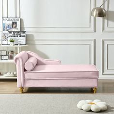 a pink chaise lounger sitting on top of a white rug in a living room