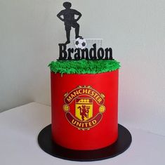 there is a cake made to look like a man's soccer uniform and the name brandon on it