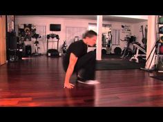 a man in black shirt doing a trick on a skateboard with his feet up