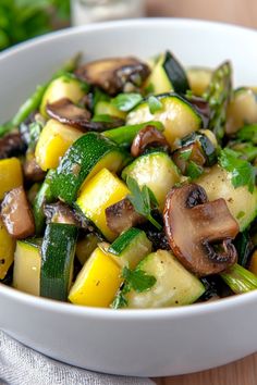 a white bowl filled with vegetables on top of a wooden table