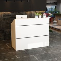 This modern and minimalist reception desk is the perfect addition to your business space, combining style with functionality. With a sleek white finish and contrasting black trim, this reception counter creates a professional look for any setting. The back side features a spacious work surface and open storage area, keeping your workspace organized and clutter-free. Reception Desk Plans, White Reception Desk, Minimalist Reception, Wooden Writing Desk, Sleek Office, Modern Reception Desk, Writing Desk Modern, Modern Reception, Desk Plans