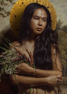 a painting of a woman with flowers in her hair and wearing a yellow headdress