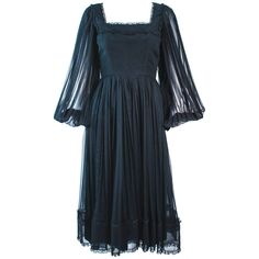 This Jean Louis dress is composed of a black sheer chiffon textured fabric with lace trim. Features pleated sheer sleeves with a beautiful square neckline. There is a center back zipper closure. In excellent condition. **Please cross-reference measurements for personal accuracy. Size in description box is an estimation. Measures (Approximately) Length: 45.5" Sleeve: 25.25" Shoulder to shoulder: 13.5" Bust: 34" Waist: 26" Hip: 39" Dress With Sheer Sleeves, Cross Reference, Sheer Chiffon, Square Necklines, Sheer Dress, Sheer Sleeves, Textured Fabric, Square Neckline, Lace Trim