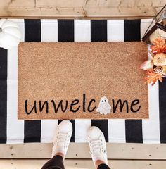 someone standing in front of a welcome mat