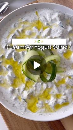 a white bowl filled with cucumber yogurt salad