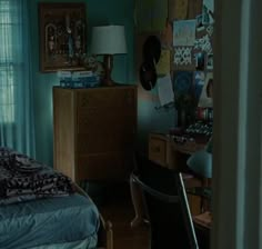 a bedroom with blue walls and wooden furniture