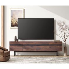 an entertainment center with a flat screen tv mounted on it's side, in a living room