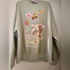 This Delightful Strawberry Shortcake Sweatshirt Is Perfect For Any Fan Of The Beloved 90s Character. With A Fun Flying Kites Pattern And A Cozy Pullover Design, This Sweatshirt Is Ideal For Fall, Winter, And Spring Wear. The Crew Neck And Long Sleeves Make It A Great Activewear Option For Walking Or Other Outdoor Activities. Crafted From A Soft And Durable Blend Of Cotton And Polyester, This Sweatshirt Is Easy To Care For With Machine Washing. The Green Color And Strawberry Shortcake Theme Make Cute Oversized Spring Sweatshirt, Cute Green Sweatshirt For Spring, Vintage Sweater For Streetwear In Spring, Vintage Sweater For Spring Streetwear, Vintage Graphic Print Sweater For Spring, Oversized Vintage Sweatshirt For Spring, Oversized Vintage Spring Sweatshirt, Retro Oversized Sweatshirt For Spring, Oversized Retro Sweatshirt For Spring