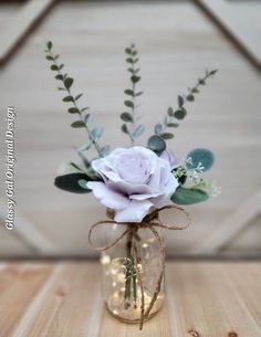 a vase filled with flowers on top of a wooden table