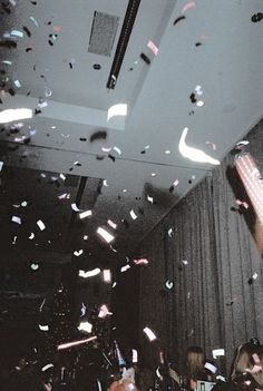 black and white photograph of confetti falling from the ceiling