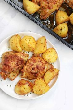 some chicken and potatoes on a white plate