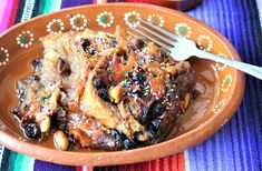 a brown plate topped with french toast covered in chocolate and sprinkles next to a fork