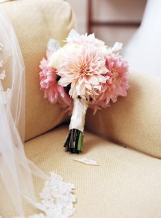 a bridal bouquet sitting on top of a chair