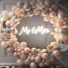 a wreath made out of balloons with the word merma written in white on it