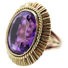 Vintage from the 1920s Size: 6.5 US Materials: Stone Gemstone: Amethyst Gem color: Purple Band Color: Purple Style: Art deco Magnificent Vintage Cocktail ring from the 20s, maybe earlier. Beautiful treasure. 14k Yellow Gold ring. Hand Made. Total weight 13.4 grams. Huge Oval cut Amethyst. Measured 20mm by 15mm by 10mm. Total estimated CTW is 16. Amethyst has shows some wear. Not seen when worn. All of our pieces are priced below appraisal and fair, but if you love a piece and would love to make an offer, don't hesitate. We at VoxMarket would appreciate and love your business. Cocktail Vintage, Wide Wedding Bands, 14k Gold Wedding Band, Amethyst Set, Purple Style, Green Amethyst Ring, Vintage Cocktail Ring, Gold Cocktail Ring, Ring Hand