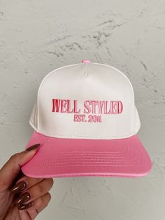 Stay stylish and playful with this white trucker hat! Featuring a pink bill and "Well Styled. Est. 2011" embroidery, this hat will elevate any outfit. Perfect for a day out, the adjustable snapback ensures a comfortable fit. Rep our stylish journey since Ruthie Grace opened in 2011! Adjustable snapback Inner headband lining Height: 3.75in Bill width: 7in Pink Hat Outfit, White Trucker Hat, Athleisure Summer, Maxi Outfits, Better Style, Embroidered Hat, Denim Accessories, Pink Hat, Embroidered Hats