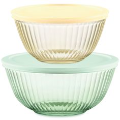 two glass bowls sitting side by side, one with yellow lid and the other green