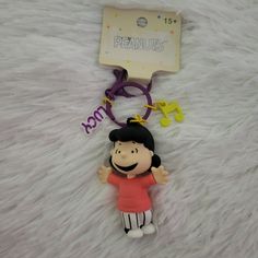 a keychain with a cartoon character on it and a name tag attached to it