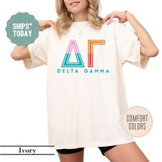 a woman wearing a t - shirt with the letters delta gama printed on it