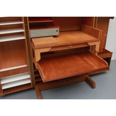 an open wooden cabinet with drawers and shelves