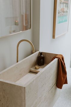 a bathroom sink with a towel hanging on the wall