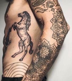 a man with a horse tattoo on his arm