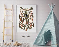 a child's room with a teepee tent and wall art