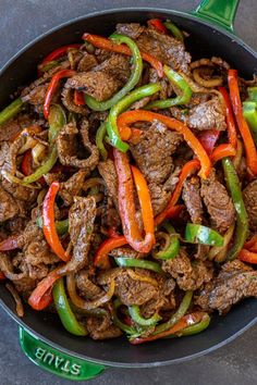 a skillet filled with beef and peppers