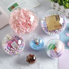 four glass bowls filled with candy and candies on top of a white tablecloth